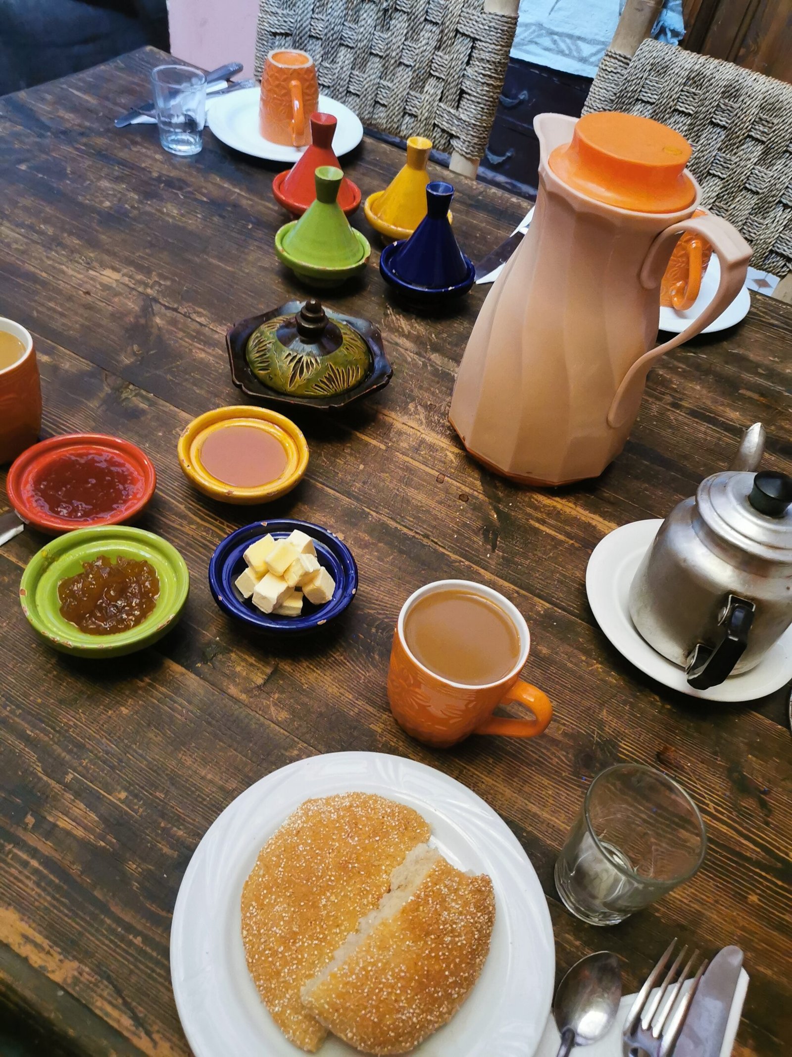 Moroccan breakfast table with tagines and mint tea.