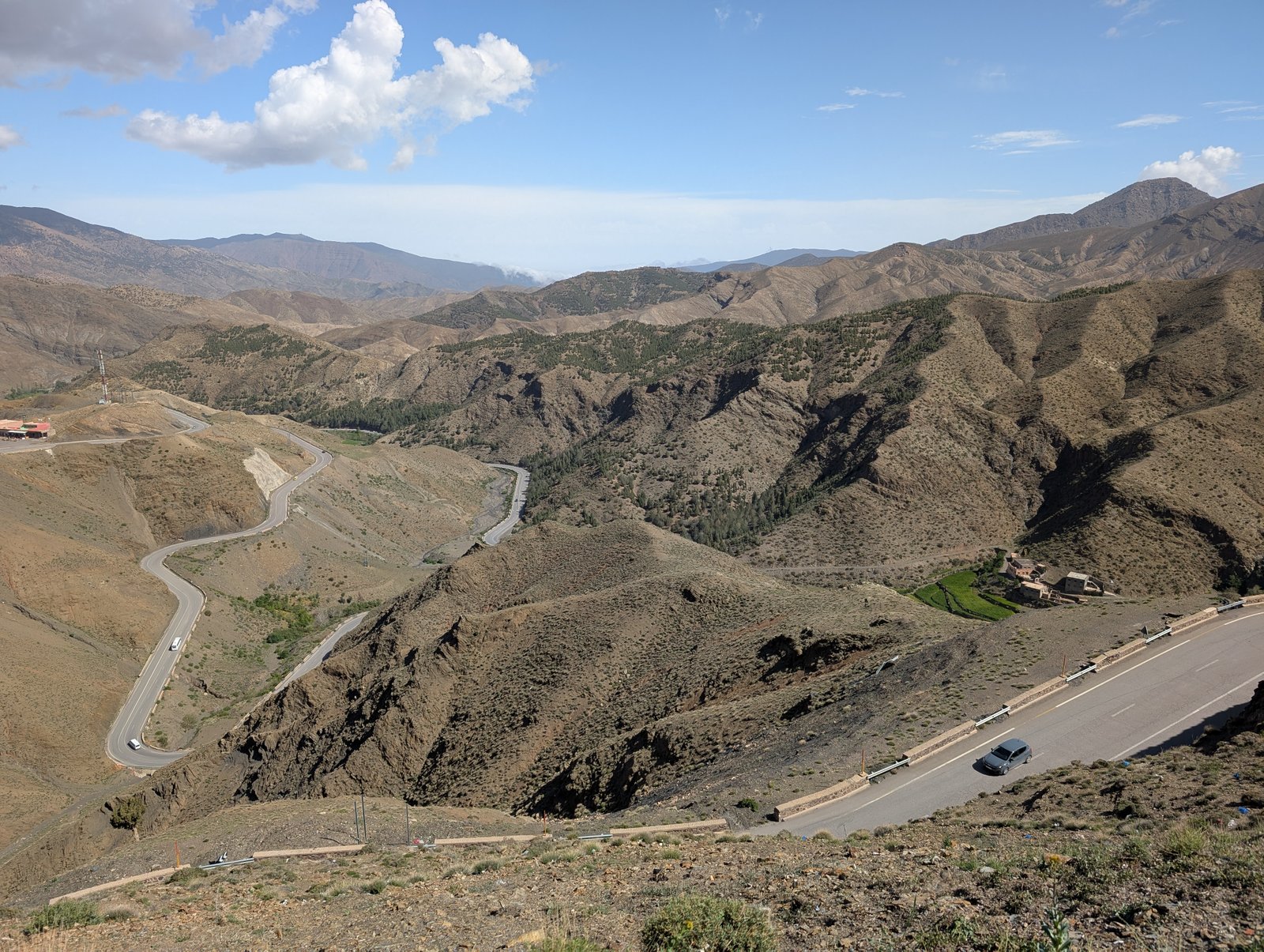 Road through Morocco's countryside with warm light and distant mountains.